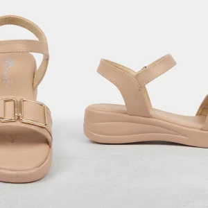 Women's beige comfort sandals with adjustable ankle strap, gold buckle detail, cushioned sole, and lightweight casual design displayed from front and side views.