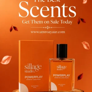 Sillage Studio Powerplay Eau De Parfum 50ml glass perfume bottle next to its vibrant orange packaging on a wood display