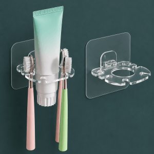 Transparent wall mounted toothbrush holder with toothpaste stand and strong adhesive backing for organizing toothbrushes and bathroom accessories.