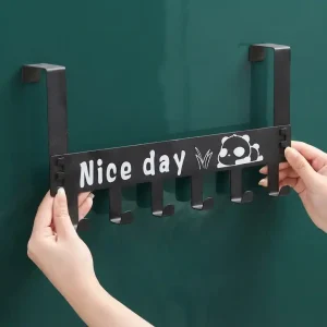 Black metal over-the-door hook hanger featuring six hooks and a panda Nice Day graphic being placed on a door.