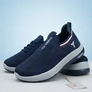 Navy blue Turbo Fit slip-on knit running shoes with white midsoles and sporty red stripe accents on a light background.
