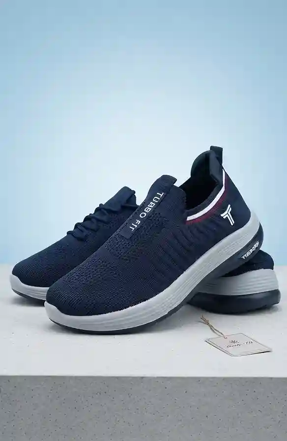 Navy blue Turbo Fit slip-on knit running shoes with white midsoles and sporty red stripe accents on a light background.