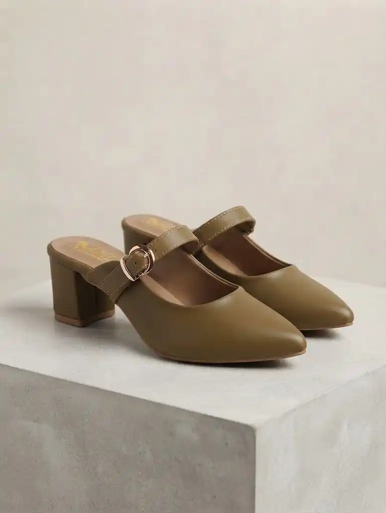 Pair of women's olive green pointed-toe block heel mule pumps with gold buckle straps displayed on a stone pedestal.