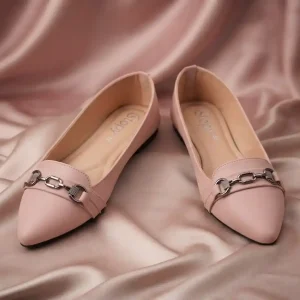 Pair of women's soft pink pointed-toe flat pumps with gunmetal chain buckles displayed on a glossy silk fabric background.